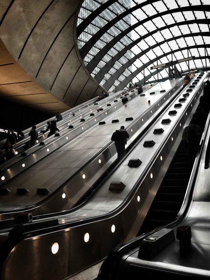 Futuristic escalators with a modern architectural design inside a London subway station.